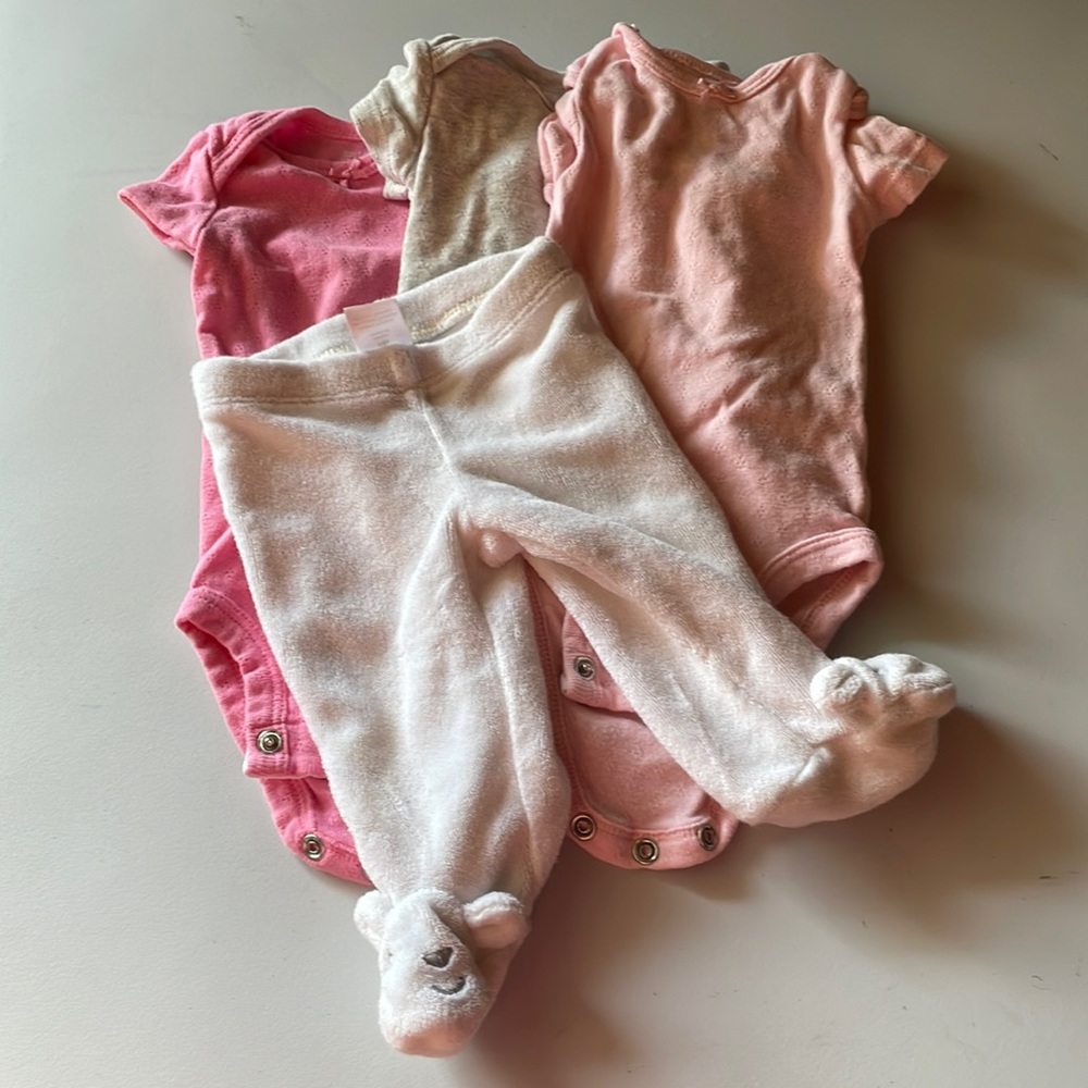 Carter’s newborn onesies pink three set an a pair of their pants with feet white